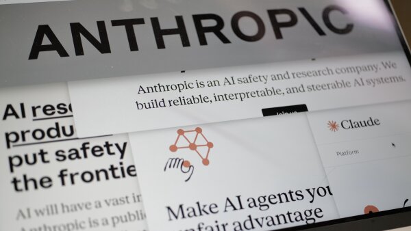 An opened laptop showing a screen that says ‘ANTHROPIC’ across the top. On the screen there are multiple sections that talk about AI. 