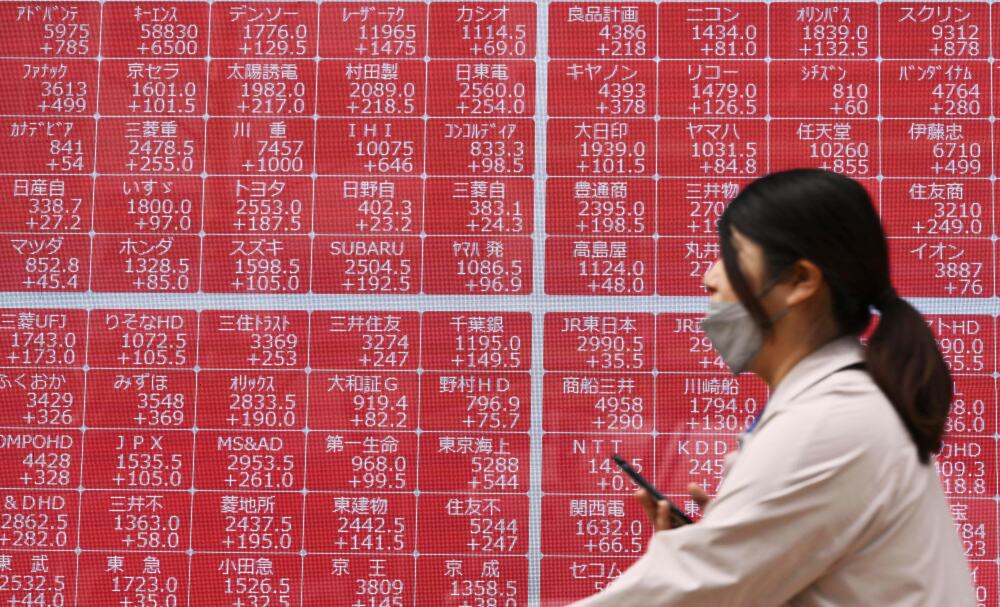 A person walks past an electronic stock board at a securities firm in Tokyo on Thursday. (Kyodo News)