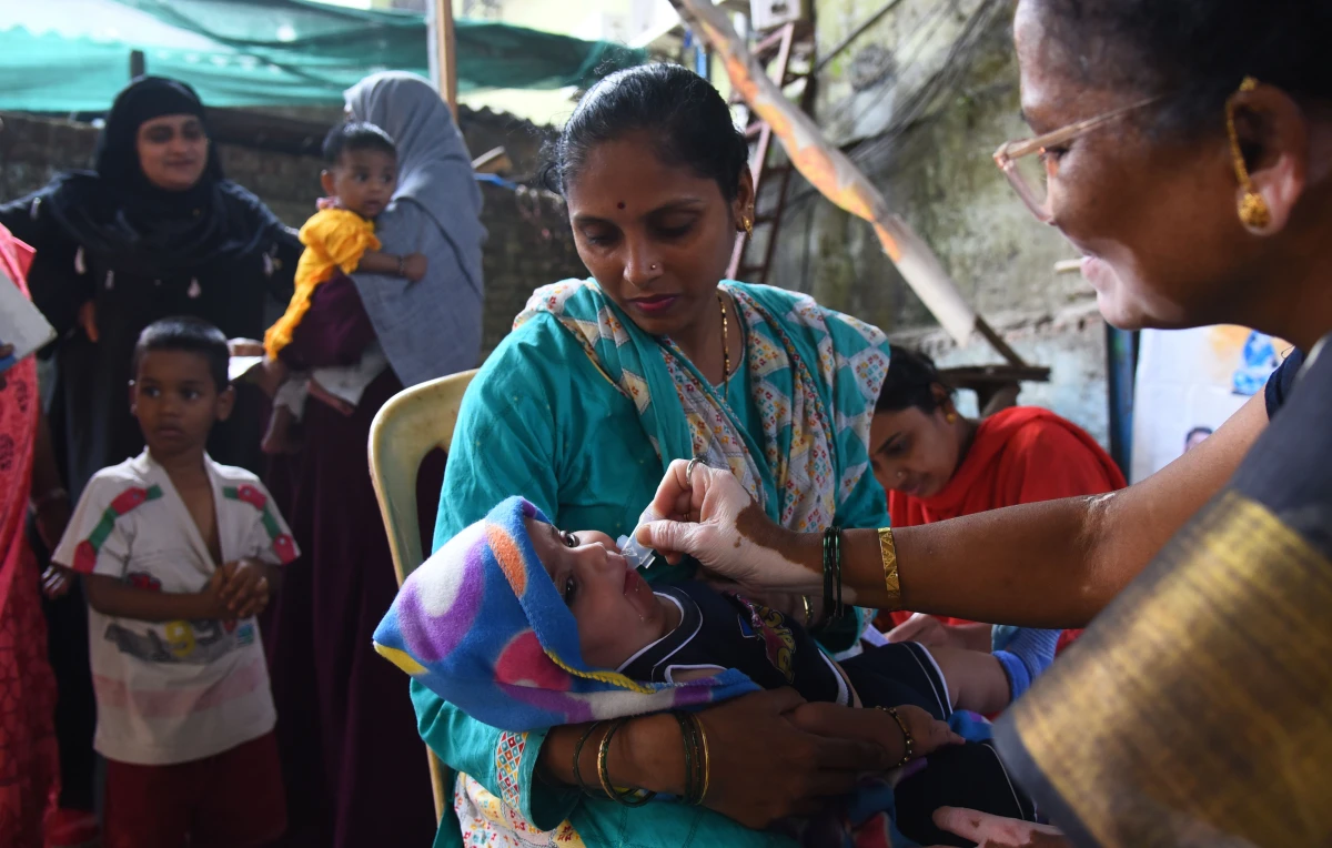 A health care worker administers a measles vaccine to a child at a temporary vaccination camp following an outbreak in Mumbai. India is among the countries that get vaccination support from Gavi, the Vaccine Alliance, whose USAID funding has been terminated.