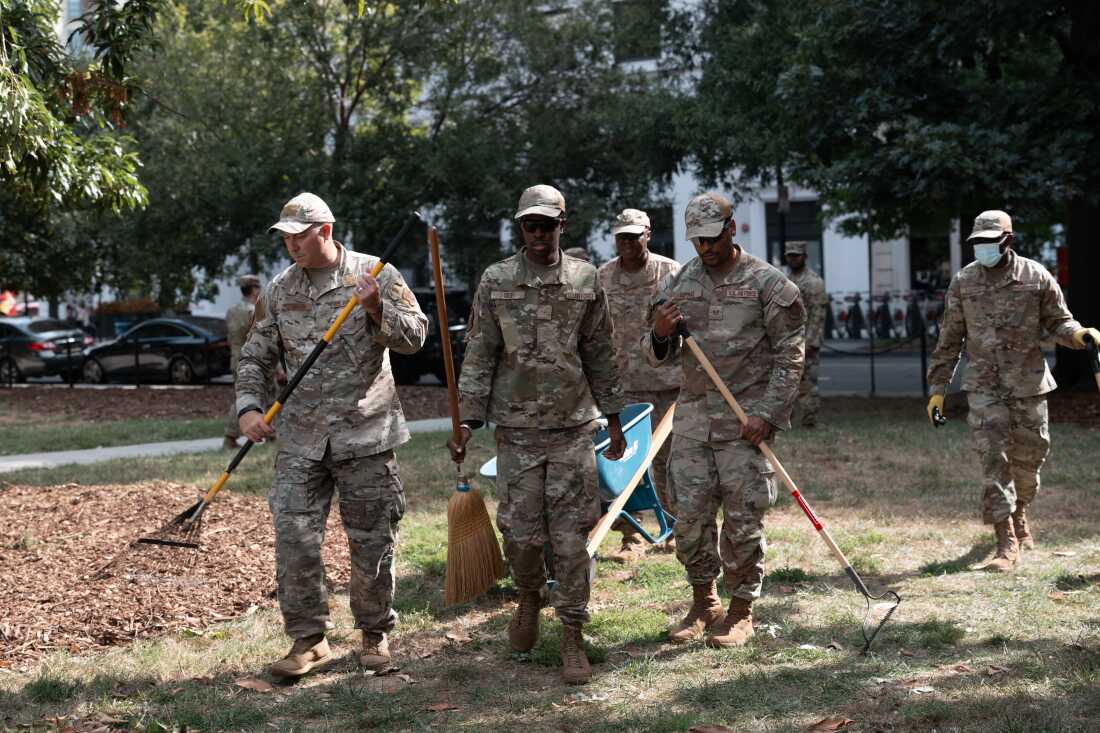 Air National Guard airmen work clearing leaves and debris from McPherson Square Park on August 28, 2025 in Washington, DC.