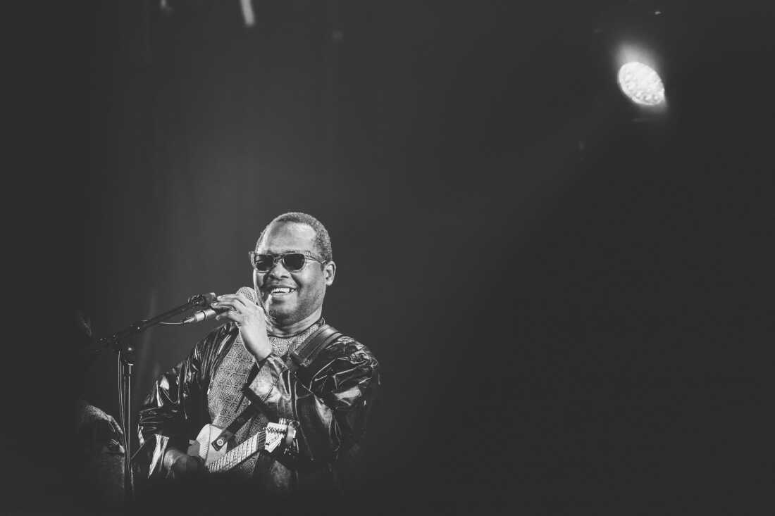 Black and white photography. Malian singer Amadou Bagayoko sings at the front during the last concert of their French tour, at the Chabada venue in Angers on November 29, 2024.Photographie Noir et blanc. Le chanteur Malien Amadou Bagayoko chante devant lors du dernier concert de leur tournee en France, dans la salle du Chabada a Angers le 29 novembre 2024. (Photo by David Pillet / Hans Lucas / Hans Lucas via AFP) (Photo by DAVID PILLET/Hans Lucas/AFP via Getty Images)