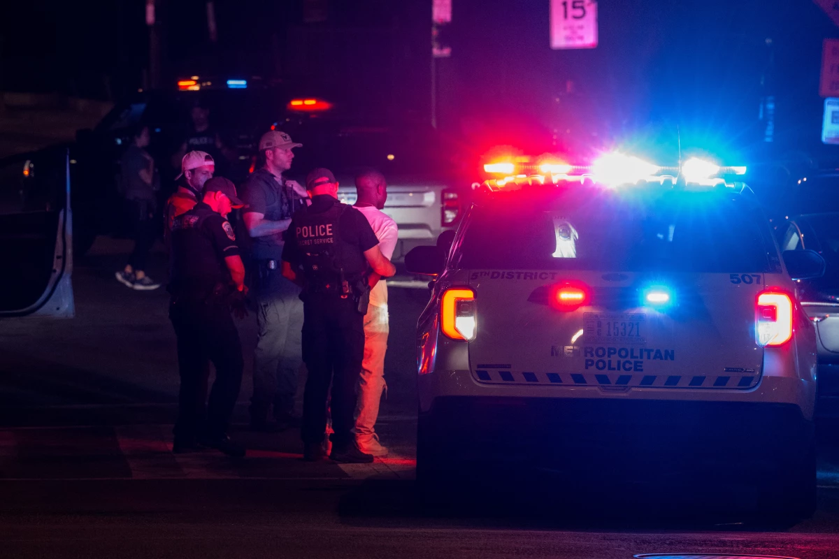 Metropolitan Police Department officers, joined by federal law enforcement agents, place a man in custody after a traffic stop in D.C. on Aug. 31.