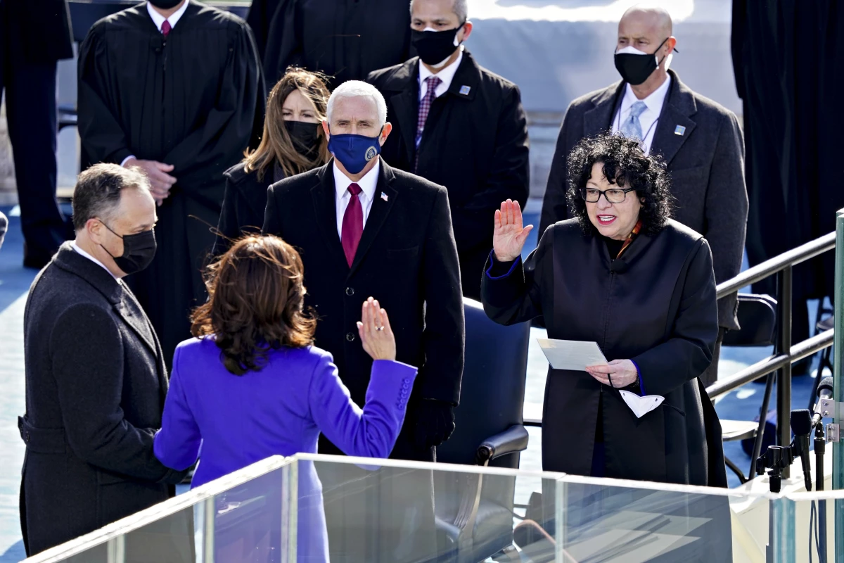 Supreme Court Justice Sonia Sotomayor (right) administers the oath of office to incoming Vice President Kamala Harris in front of the U.S. Capitol on Jan. 20, 2021, as outgoing Vice President Mike Pence (wearing blue mask) watches.