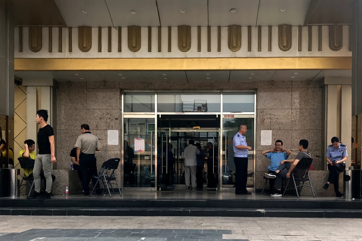 Police officers guard the main entrance door to a building where Zion Church was located after the church was shut down by authorities, in Beijing in September 2018.