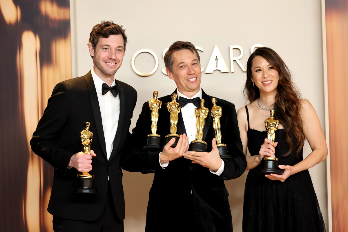 Alex Coco, left, Sean Baker and Samantha Quan pose in the press room with their Oscars for Anora.