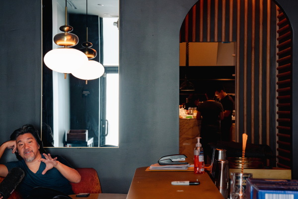 Lee speaks to a reporter inside his restaurant, Shia.