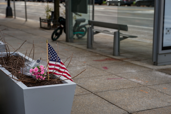 A small memorial of flowers and an American flag has been set up outside the Farragut West Metro station in Washington, D.C.