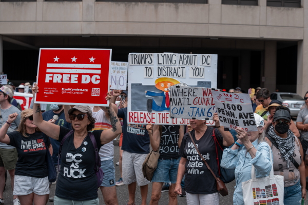 People attend a protest hosted by activists near the Washington, D.C. Metropolitan Police Department Headquarters on Friday.