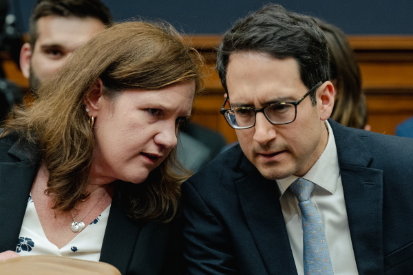 Democratic members of the Federal Trade Commission Rebecca Kelly Slaughter and Alvaro Bedoya chat during a House Judiciary Committee hearing on July 13, 2023.