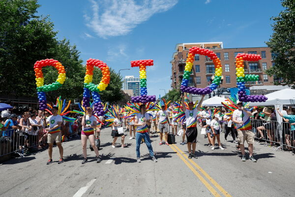 Pride: From Vice to LGBTQ+ Empowerment | NPR Participants in Chicago's LGBTQ Pride parade carry balloons spelling out 'Pride'