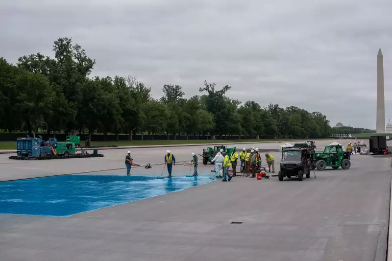 Crews paint a new blue coating on the Lincoln Memorial Reflecting Pool on Saturday.