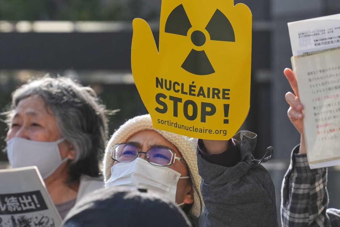 FILE -Protesters hold a sign during a rally against the restart of the No. 6 reactor at the Kashiwazaki-Kariwa nuclear power plant, in front of Tokyo Electric Power Company Holdings (TEPCO) headquarters in Tokyo, Jan. 19, 2026.