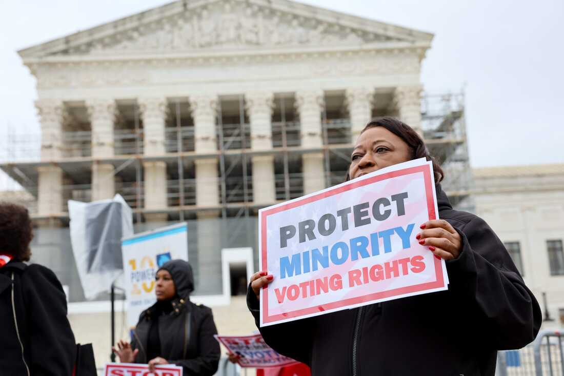 A demonstrator holds a sign saying “PROTECT MINORITY VOTING RIGHTS” at a March 2025 rally outside the U.S. Supreme Court in Washington, D.C.