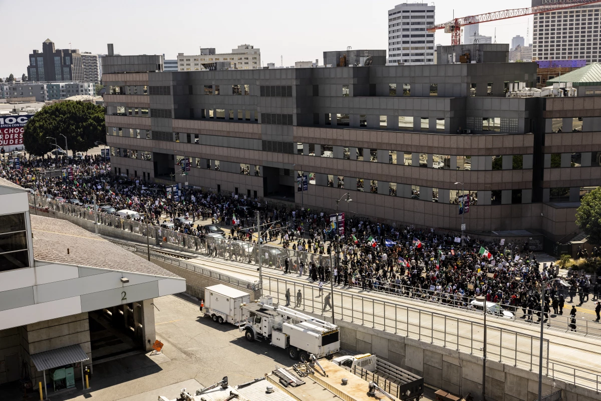 Law enforcement clash with demonstrators in front of a federal building during a protest in Los Angeles on Sunday.