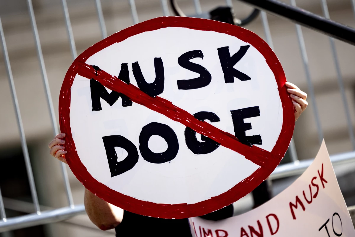A demonstrator holds a sign during a February rally in Los Angeles to protest President Trump's billionaire adviser Elon Musk and his DOGE team.