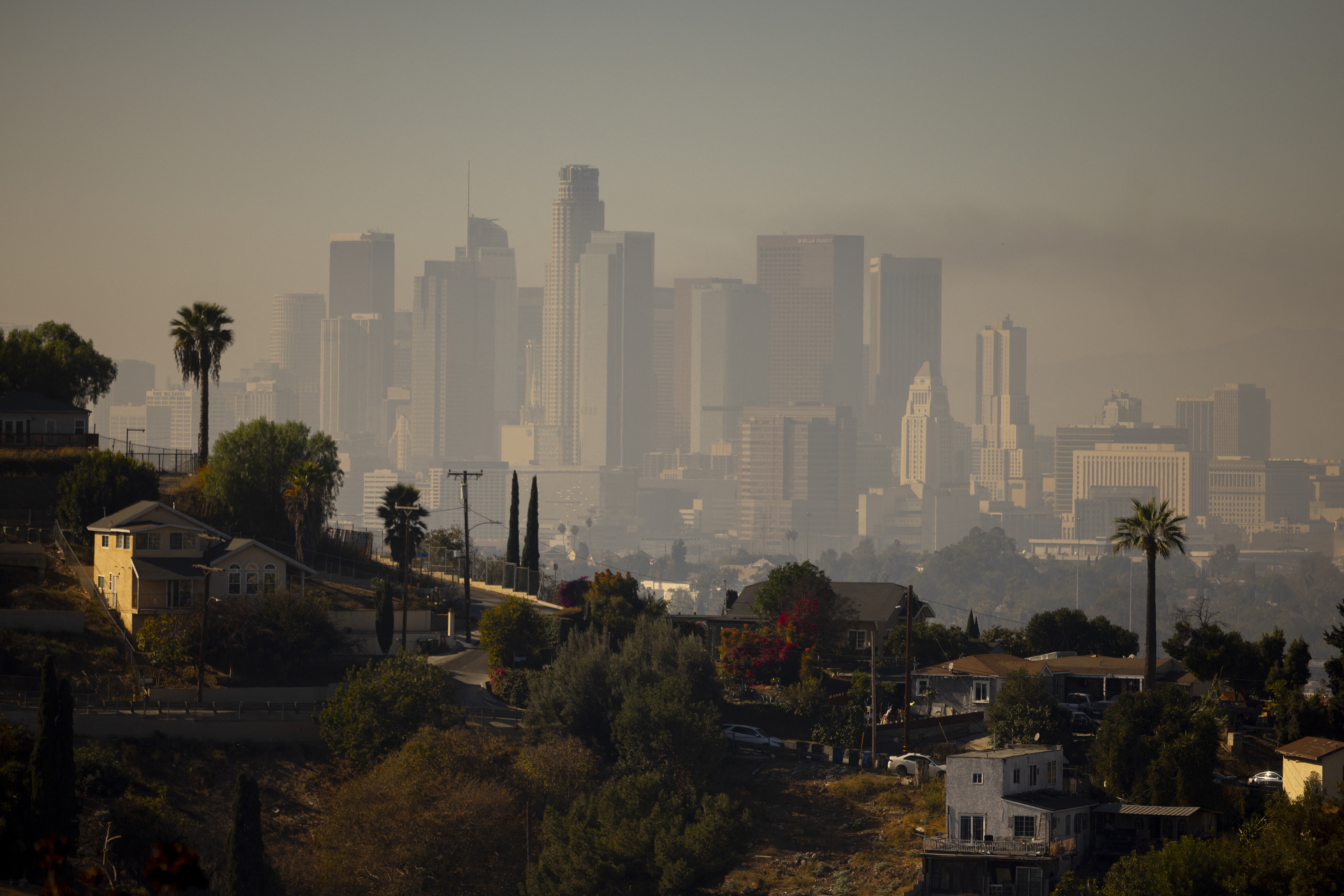A layer of smog lingers above downtown Los Angeles in 2024. Millions of Americans are still breathing in unhealthy air, despite long-term progress toward cleaning up many sources of pollution, according to the 2025 State of the Air report.