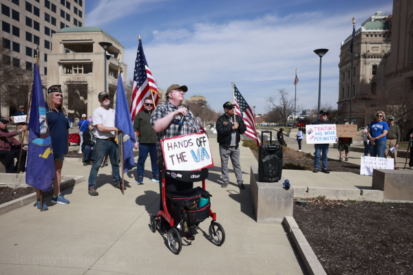 Protesters gather in Indianapolis on March 14. One man carries a homemade sign that reads, "Hands off the VA."