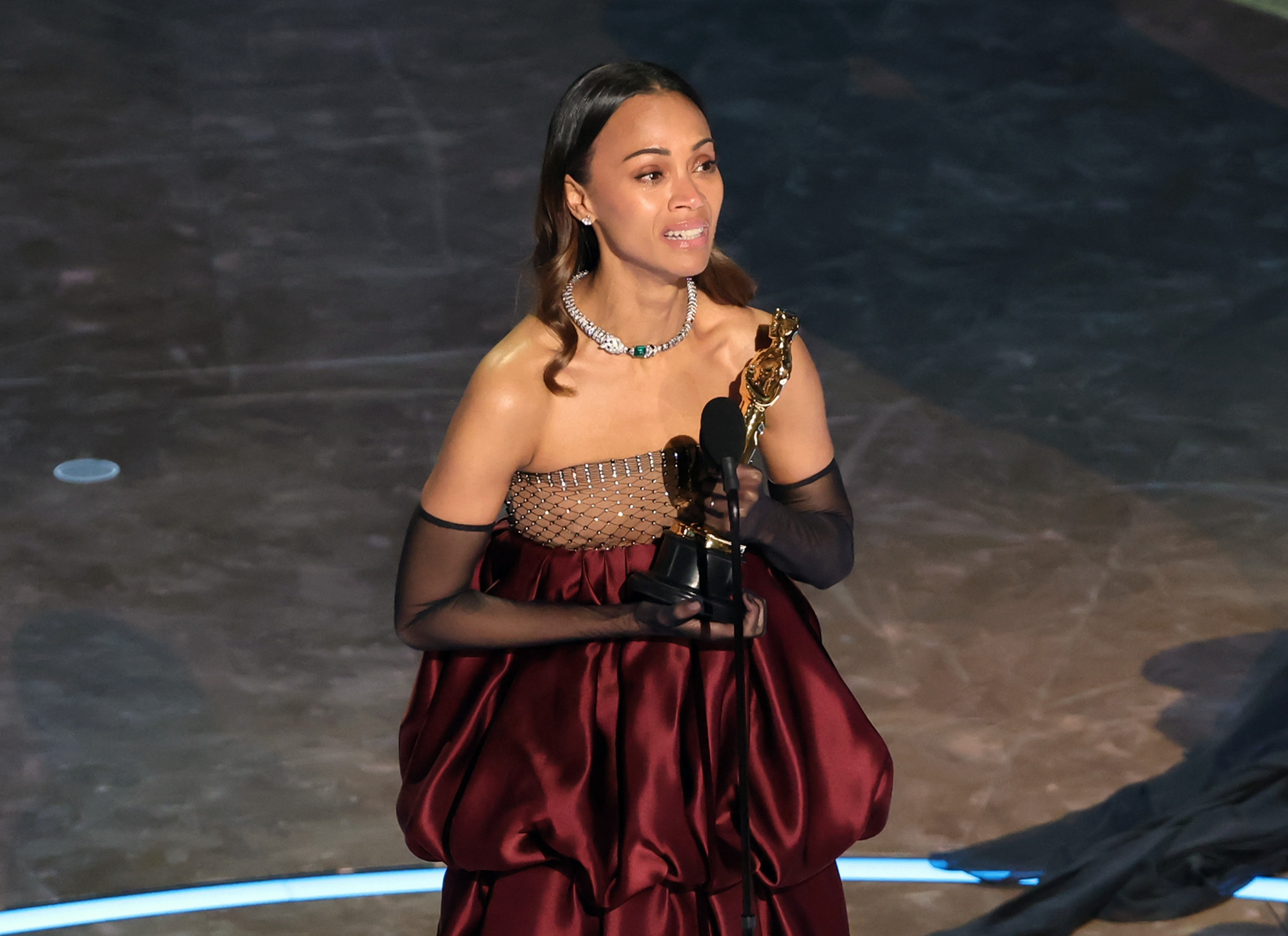 Zoe Saldaña accepts the best actress in a supporting role award for <!-- raw HTML omitted -->Emilia Pérez<!-- raw HTML omitted --> during the 97th Annual Oscars at Dolby Theatre in Hollywood, Calif.