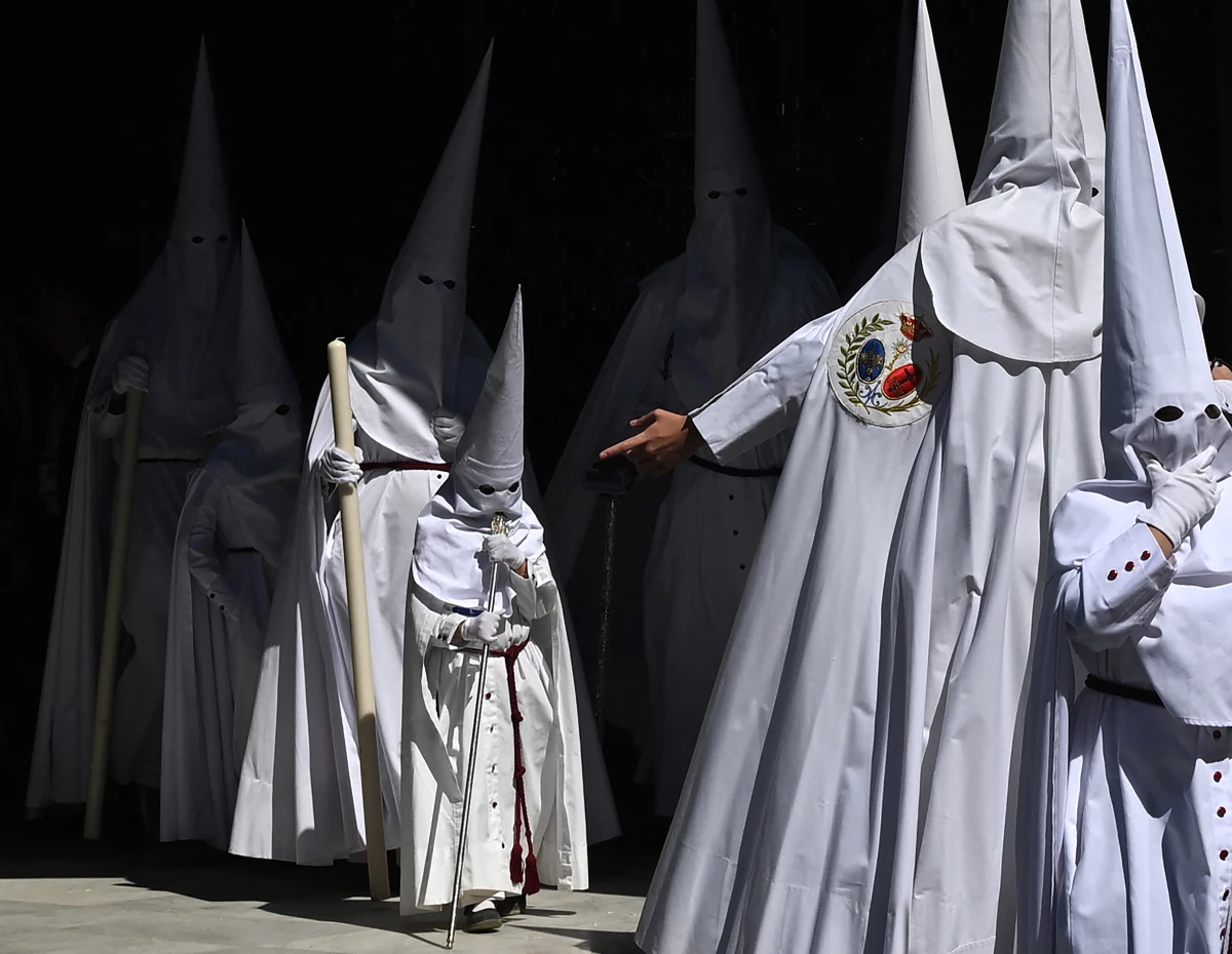 Penitents partake in the Palm Sunday procession in Seville.