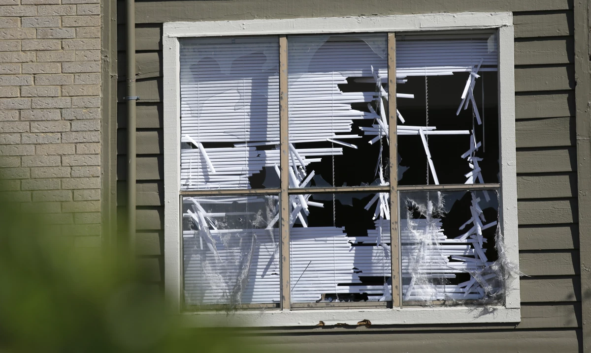Blinds are shredded in windows broken by a hail storm in Plano, Texas, in 2016.