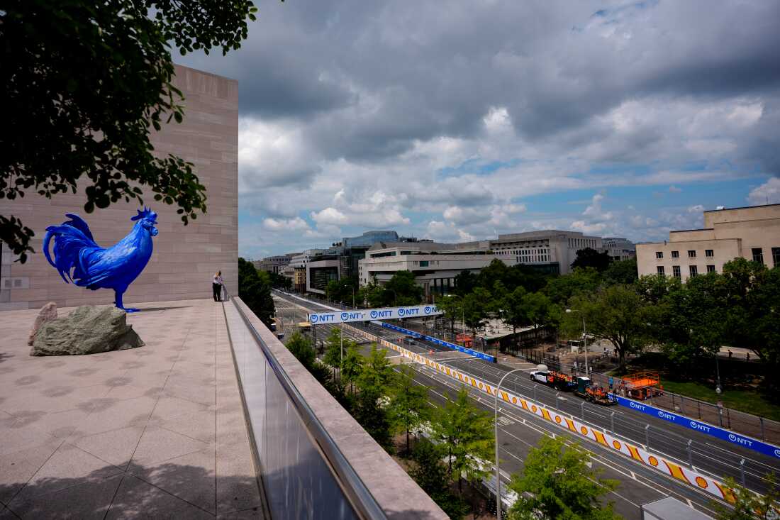 A14-foot tall blue rooster sculpture overlooks the race track from the roof of the National Gallery of Art's East Building in Washington, D.C.