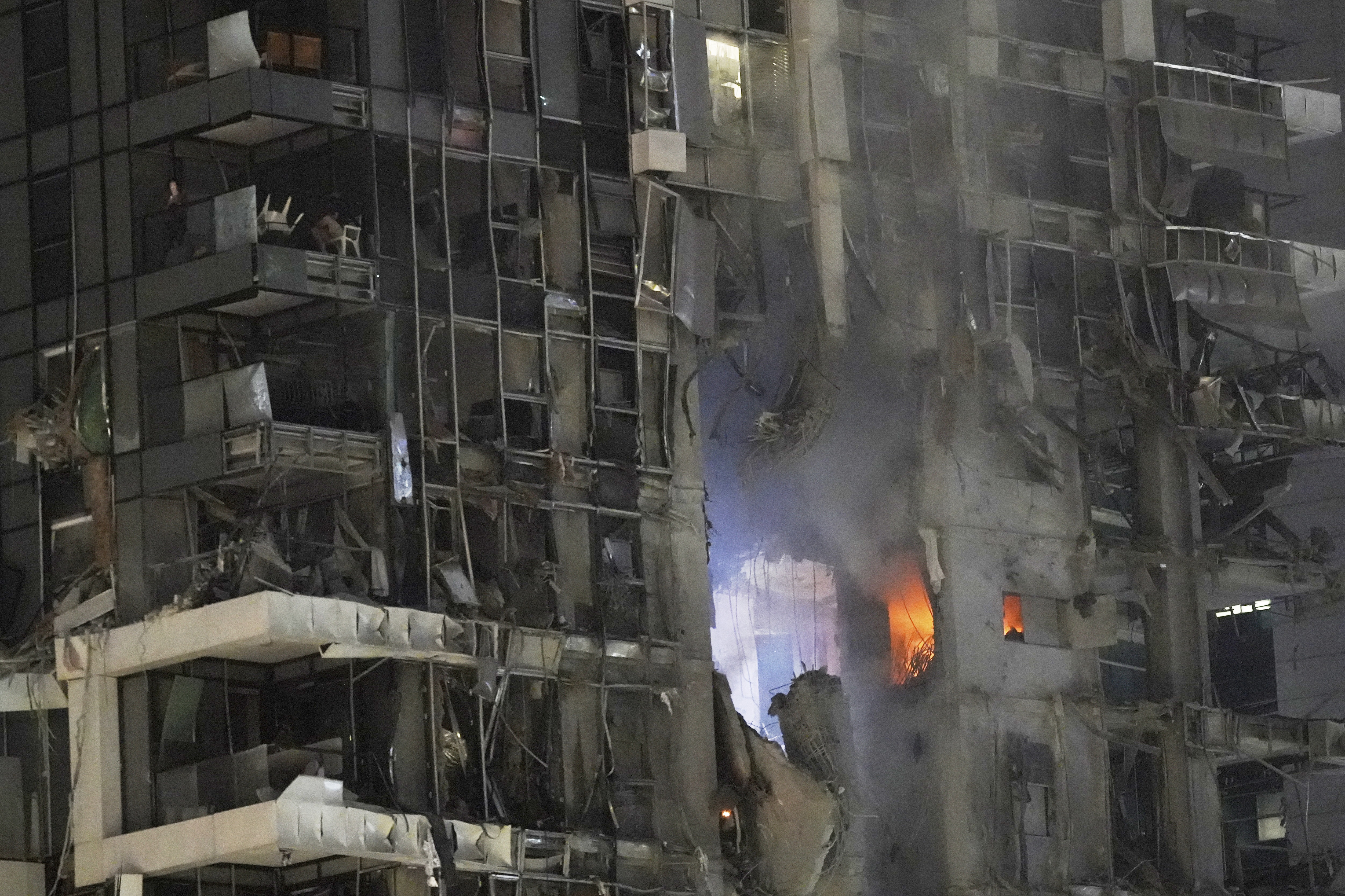 Fire and smoke rises from a destroyed building that was hit by a missile fired from Iran, in Tel Aviv, Israel on June 13, (AP)