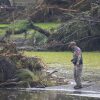 A Texas Department of Public Safety official inspects debris on the waterfront at Camp Mystic along the banks of the Guadalupe River after a flash flood swept through the area Sunday, July 6, in Hunt, Texas.