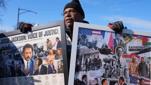 James Hickman holds a photo montage of the late Rev. Jesse Jackson before a public visitation at Rainbow/PUSH Coalition in Chicago on Thursday.