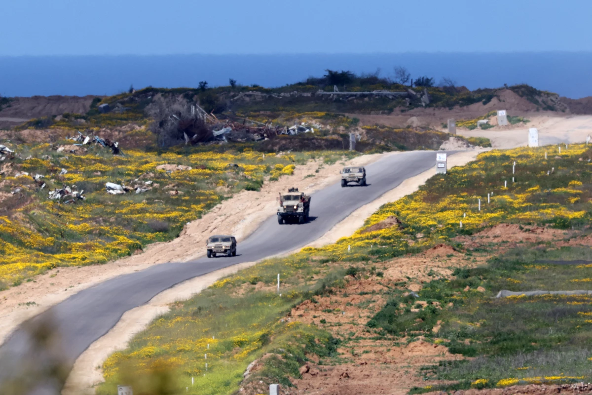 In this picture, taken from Israel's southern border with the Gaza Strip, Israeli soldiers patrol a street in northern Gaza on Wednesday. The Israeli military says it's launched a new ground offensive in Gaza, a day after Israel broke a ceasefire with a punishing series of airstrikes that killed more than 400 people.