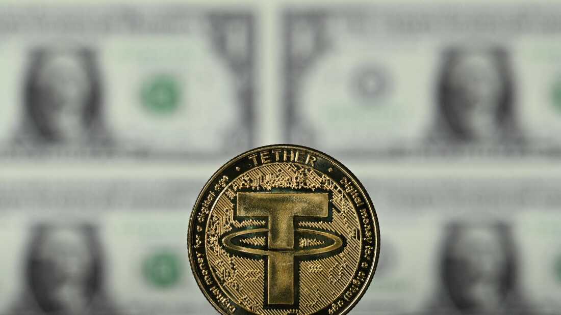 An illustration picture taken in London on May 8, 2022, shows a souvenir Tether (USDT) coin, which is one of the world's biggest stablecoins.