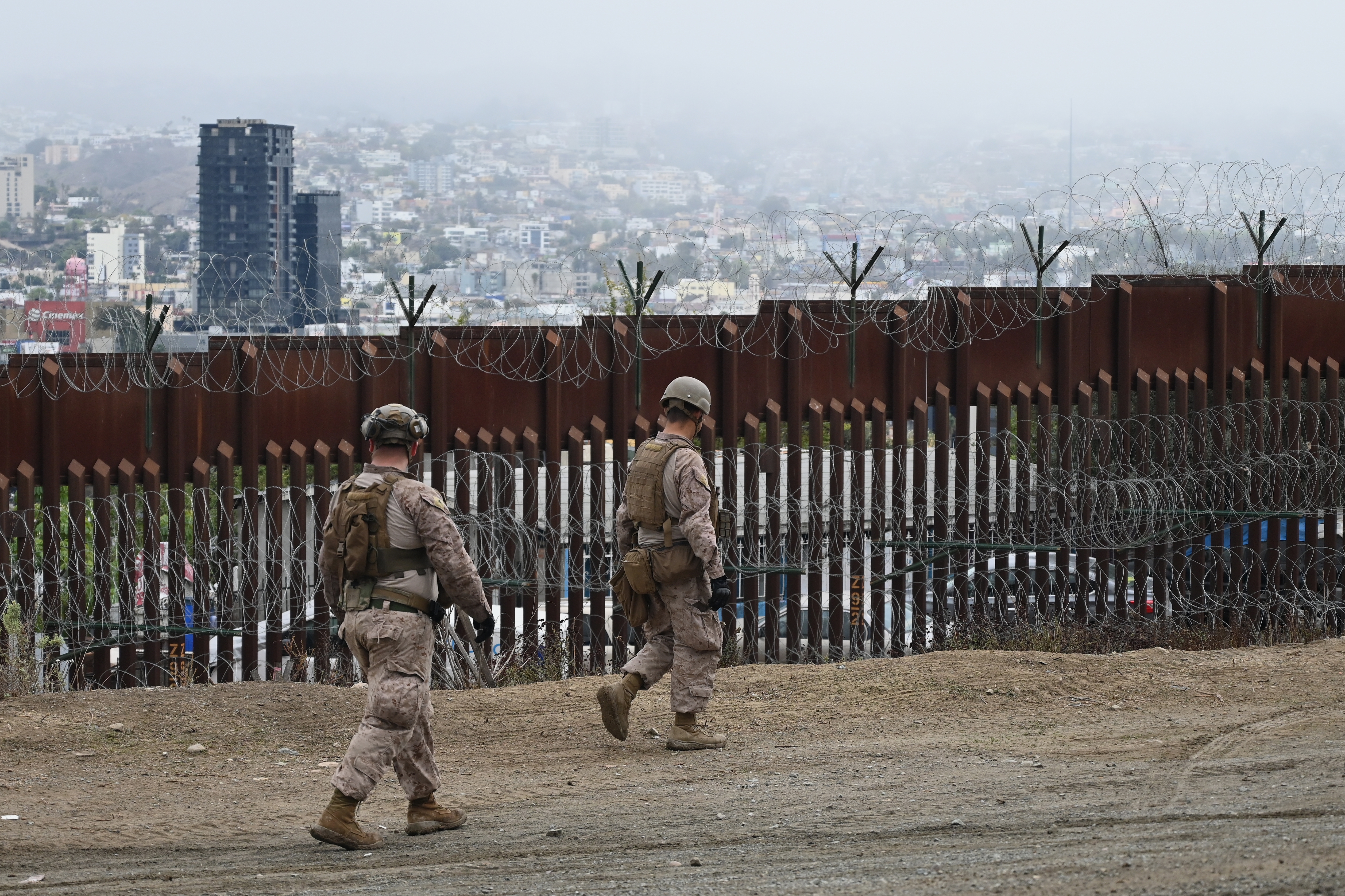 Members of the U.S. Marine Corps patrol the U.S.-Mexico border area as seen from San Diego on Feb. 7.