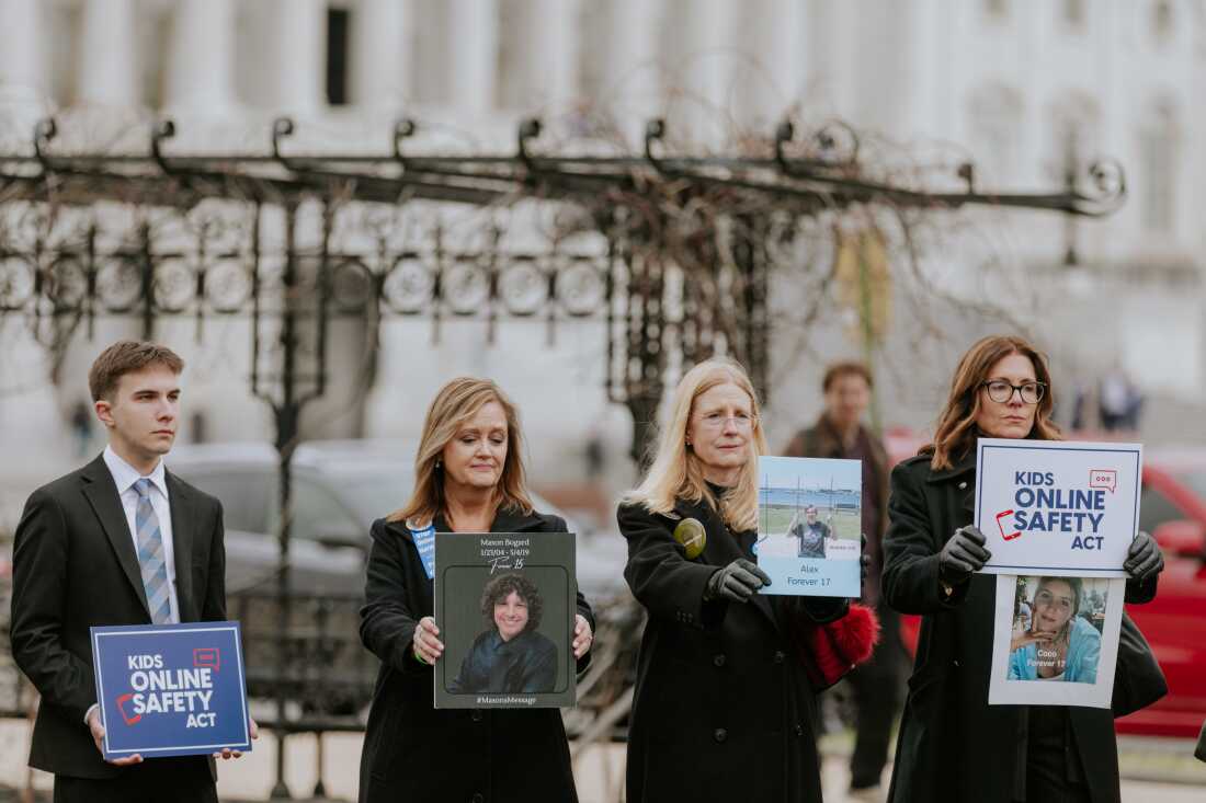 Members of advocacy group Parents for Safe Online Spaces hold signs of their children after a Big Tech hearing on Capitol Hill in January in Washington, D.C.