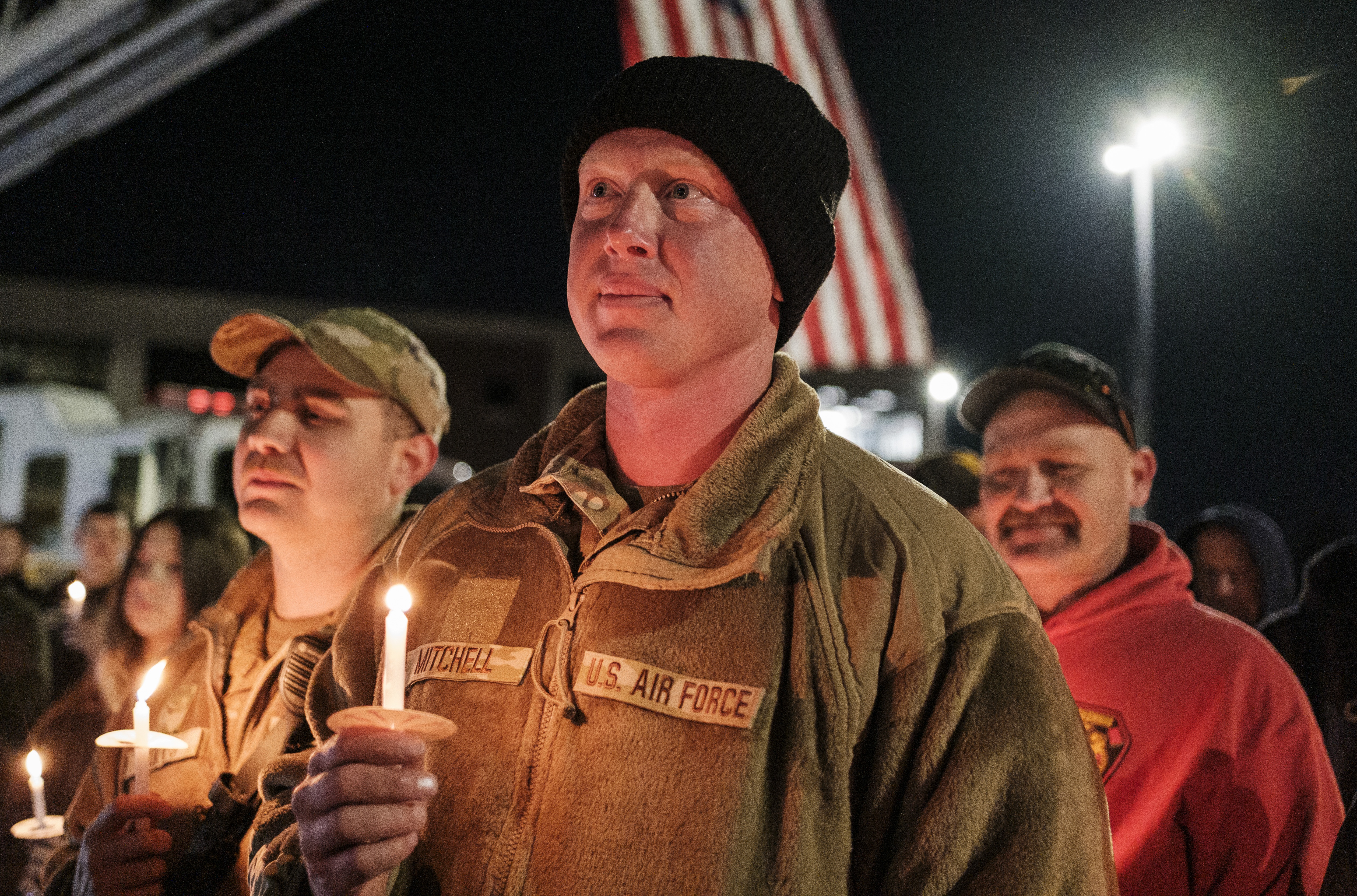 Staff Sgt. Jason Mitchell, a member of the West Virginia Air National Guard, attends a candlelight vigil for Staff Sgt. Andrew Wolfe outside the Berkeley County Sheriff
