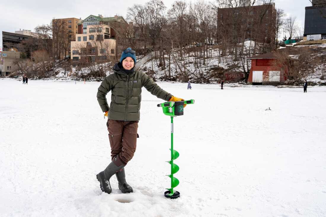Hilary Dugan, a limnologist and associate professor at UW-Madison, poses for a portrait behind a hole she drilled with an electric auger during the Frozen Assets Festival on Lake Mendota on Saturday, Feb. 7, 2026, in Madison, Wisconsin. Photo by Kayla Wolf