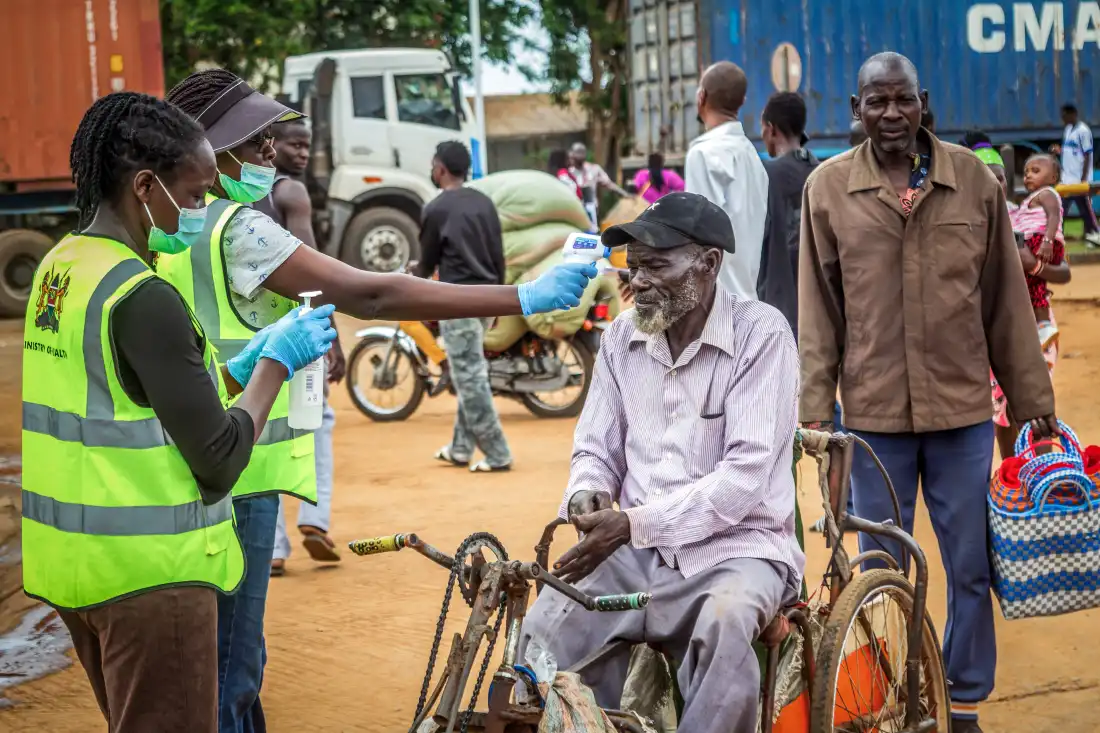 A Kenyan Ministry of Health official checks the temperature of a traveler on the Kenya-Uganda border as health authorities step up Ebola screening measures, On October 12, Kenya reported its first-ever Ebola death — a Kenyan man who had been living in the Democratic Republic of Congo died after returning to the country.