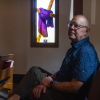 The Rev. Steve Sylvester sits in a pew at the church.
