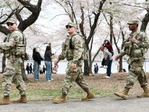 Members of the National Guard patrol the Tidal Basin as tourists visit the Cherry Blossoms on March 30, 2026 in Washington, DC.