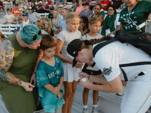 One of the LA Queens' players signs autographs for fans in the crowd during the game between the San Francisco Firebells and the Boston Hunters on Sunday, Aug. 2.