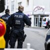 Police officers stand at a cordon in the city center in the early morning in Solingen, Germany, on Saturday, following Friday's deadly attack at the city's 650th anniversary celebrations.