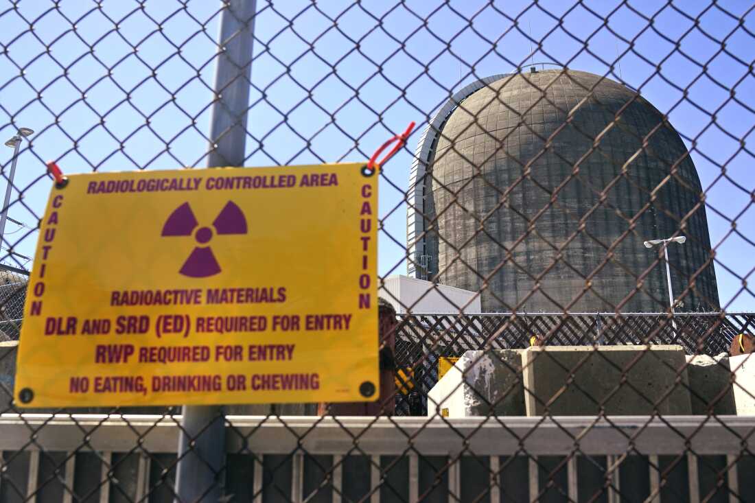 A sign warning of radioactive materials is seen on a fence outside Indian Point Energy Center in Buchanan, N.Y. just days before it close in 2021. The Trump administration is seeking to overhaul nuclear safety rules to aid a nuclear revival.