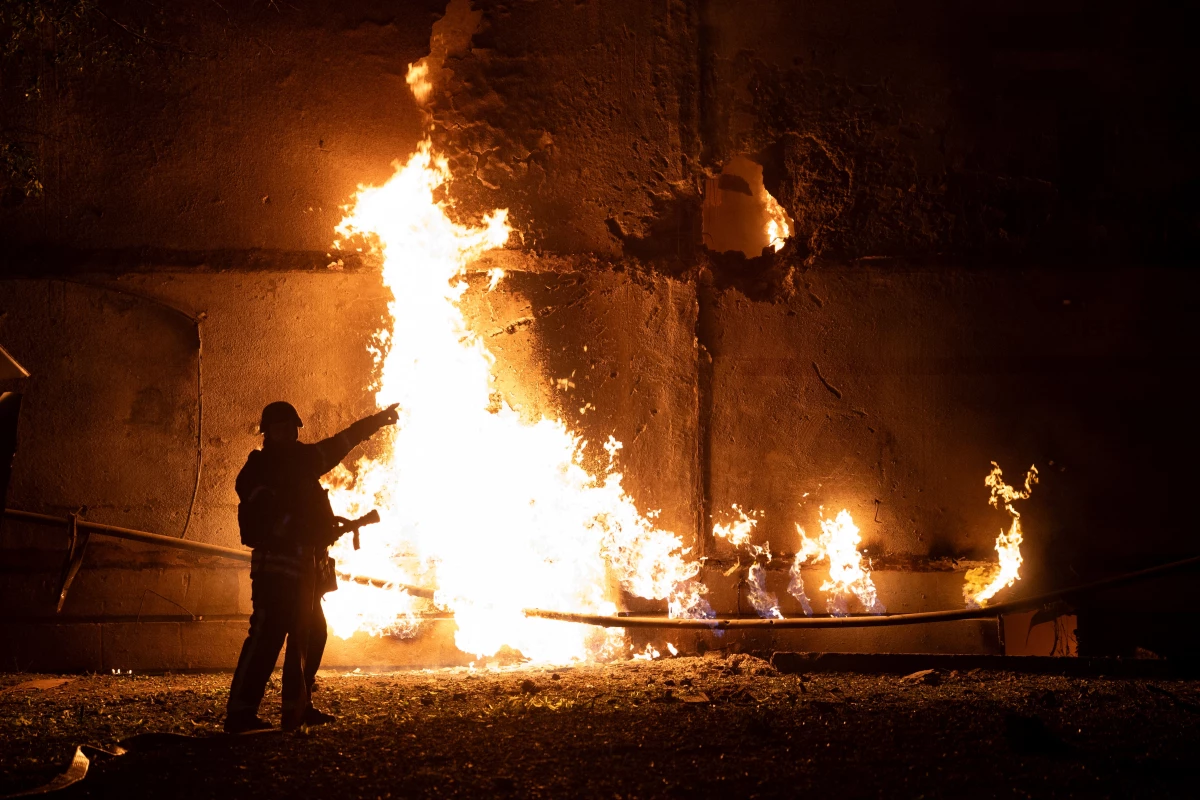 A Ukrainian firefighter responds to a drone strike in the northeastern city of Kharkiv on Thursday. Both sides have ramped up drone attacks. Russia has fired more than 400 drones at Ukraine on two separate nights in the past week, the largest numbers in the war.