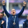 U.S. players celebrate with their bronze medals on the podium during the victory ceremony at the Paris 2024 Olympic Games.