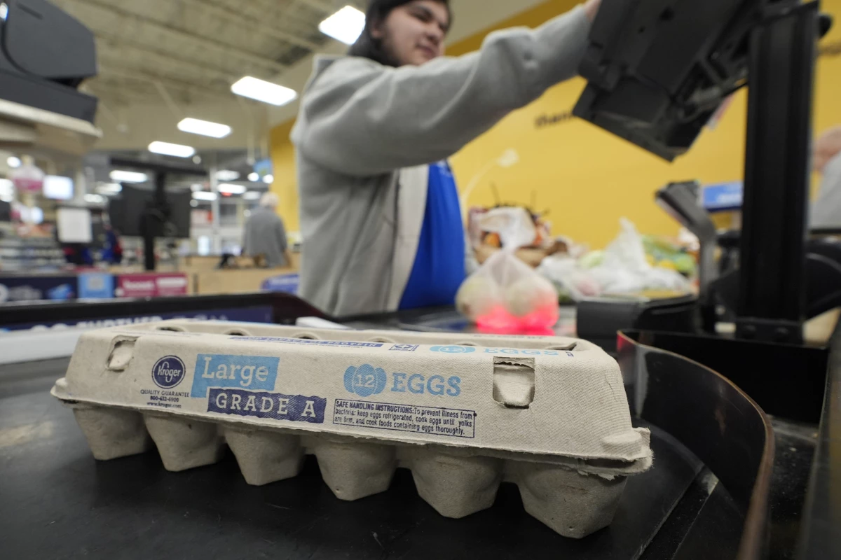 Cashier Josh Jimenez rings up egg for sale at a grocery store in Dallas.