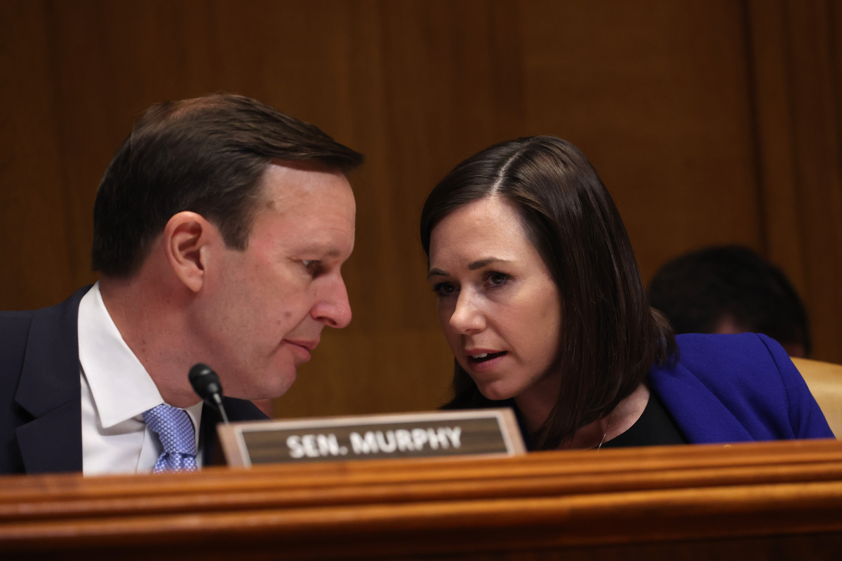 Sen. Chris Murphy, D-Conn., talks to Sen. Katie Britt, R-Ala., during a March 29, 2023 hearing on Capitol Hill.
