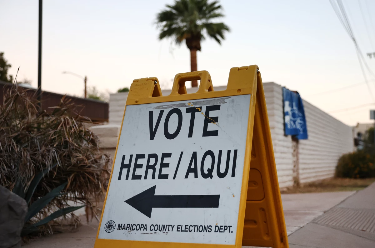 A Vote Here/Aqui sign is posted at a polling place at a church after the polls opened before sunrise on Nov. 05 in Tempe, Arizona.