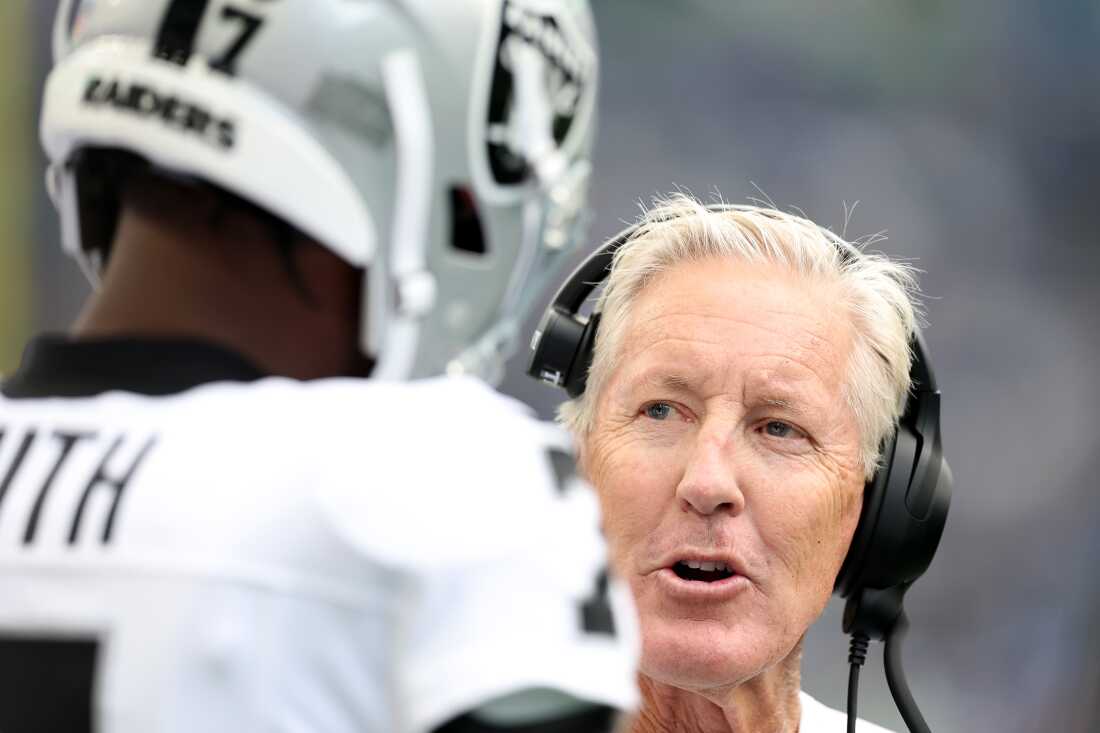 Las Vegas Raiders Head coach Pete Carroll speaks to quarterback Geno Smith during a preseason game against the Seattle Seahawks in August.