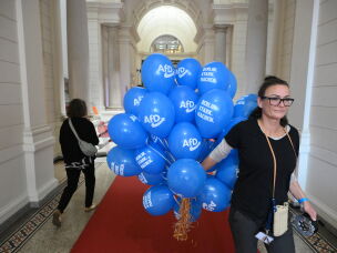 A woman carries balloons for Germany's far-right Alternative for Germany (AfD) party at the House of Representatives in Berlin during regional elections in the German capital on Sunday.