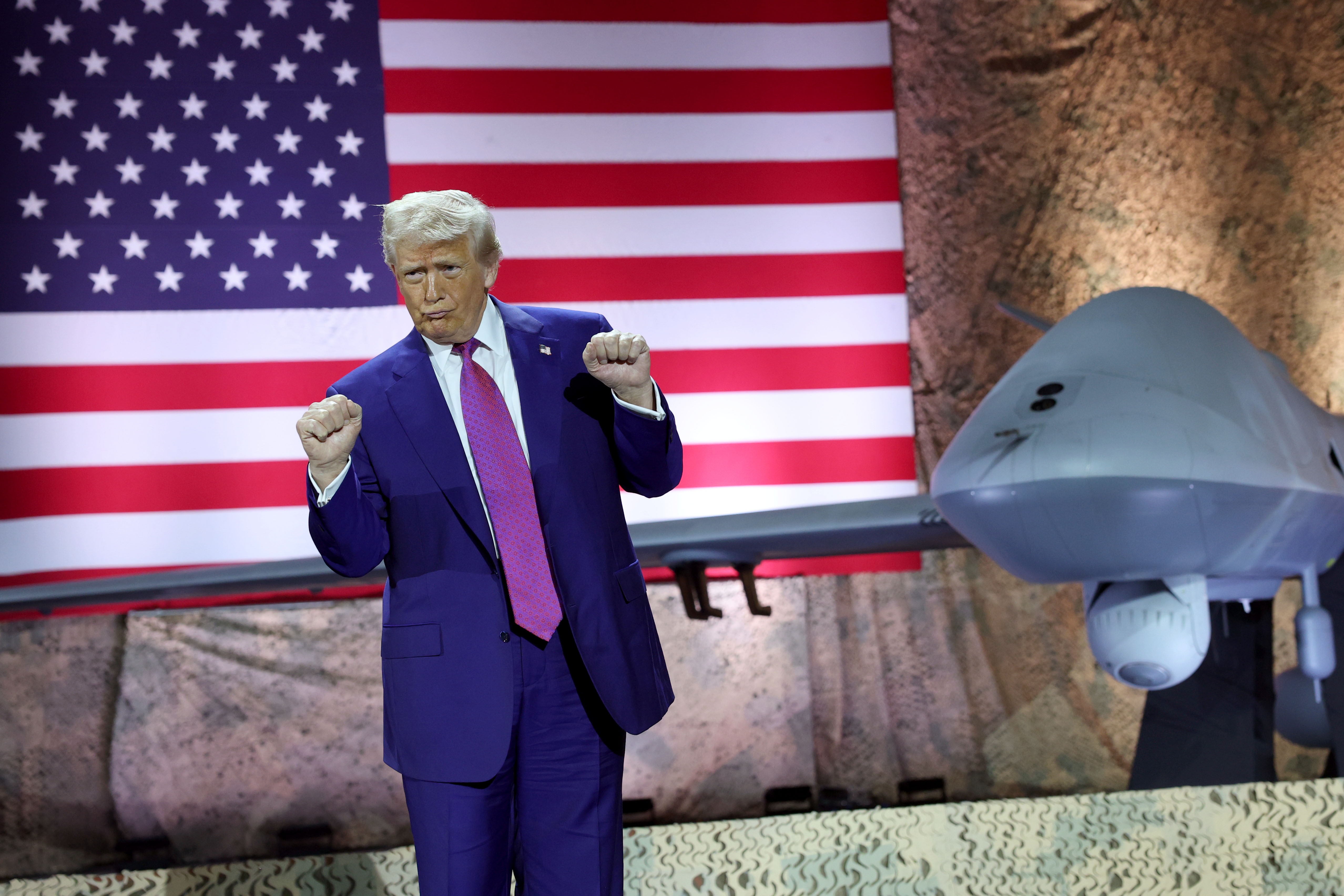 President Trump dances as his campaign song "God Bless the U.S.A." plays on stage at the Al Udeid Air Base in Qatar on May 15, 2025.