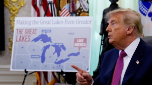 A map labeling Lake Ontario as "Lake America" is displayed as U.S. President Donald Trump takes a question from a reporter after signing an executive order during an event in the Oval Office.
