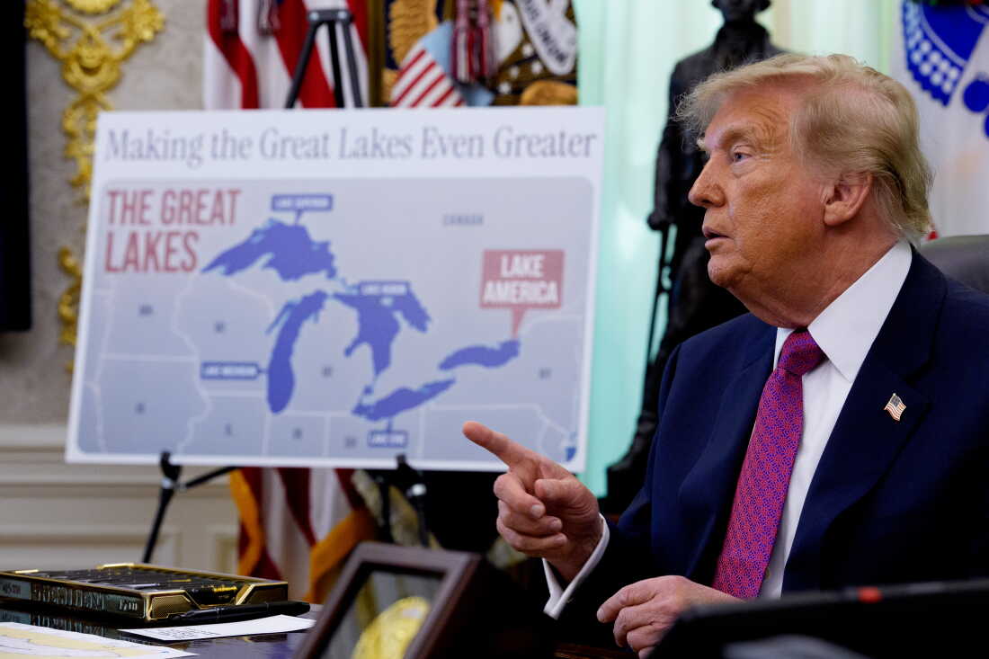 A map labeling Lake Ontario as "Lake America" is displayed as U.S. President Donald Trump takes a question from a reporter after signing an executive order during an event in the Oval Office.